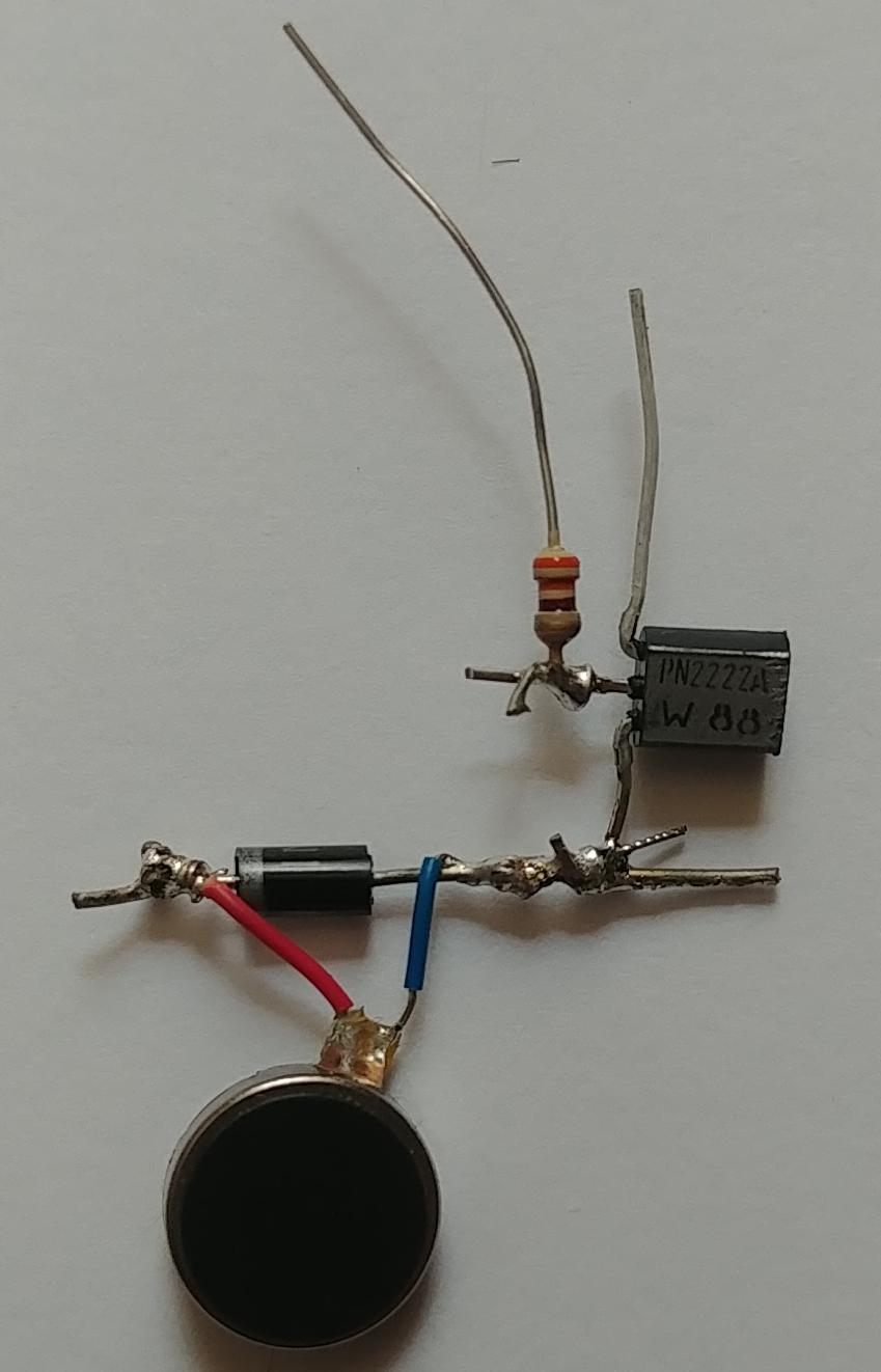 Image of the vibration motor, diode, transistor, and resistor all soldered together