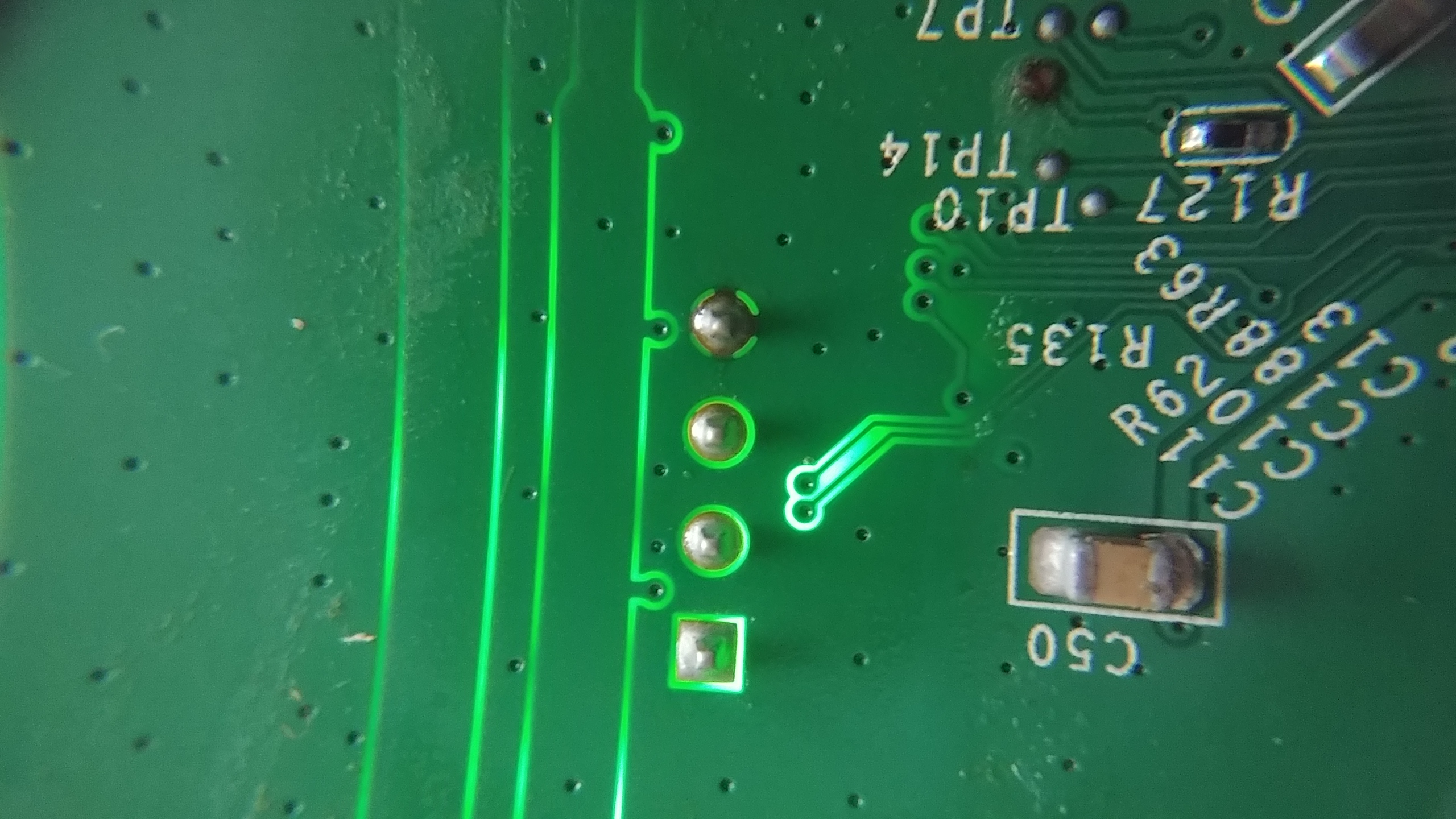 4 pins on a PCB with a light shining behind them